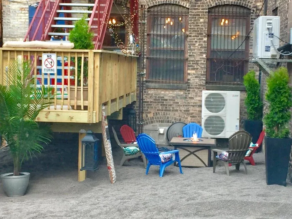 Back patio with adirondack chairs around the fire pit